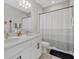 Elegant bathroom featuring double sinks, a large mirror, and a shower-tub combo at 17676 Savory Mist Cir, Bradenton, FL 34211