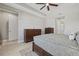 Spacious bedroom with dark wood furniture, ensuite bathroom, and natural light for a warm and inviting atmosphere at 17676 Savory Mist Cir, Bradenton, FL 34211