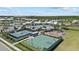 Community pool, playground, and sports courts surrounded by green space and palm trees create an inviting atmosphere at 17676 Savory Mist Cir, Bradenton, FL 34211