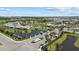 Aerial view of a beautifully landscaped community entrance with ponds, palm trees, and elegant signage at 17676 Savory Mist Cir, Bradenton, FL 34211