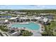Beautiful community center featuring a large pool, sundeck, tropical landscaping, and elegant architectural design at 17676 Savory Mist Cir, Bradenton, FL 34211