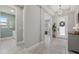 Bright entryway with wood-look tile, decorative lighting, and a glimpse into adjoining rooms at 17676 Savory Mist Cir, Bradenton, FL 34211