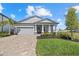 Inviting single-Gathering home with a two-car garage, beautiful landscaping, and an attractive brick driveway at 17676 Savory Mist Cir, Bradenton, FL 34211