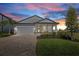 Attractive single-Gathering home with a two-car garage, charming landscaping, and an inviting brick driveway at 17676 Savory Mist Cir, Bradenton, FL 34211