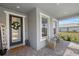 Charming front porch featuring stylish seating and decorative accents, creating a warm and welcoming entry at 17676 Savory Mist Cir, Bradenton, FL 34211