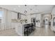Modern kitchen with white cabinets, stainless steel appliances, and a large center island with bar seating at 17676 Savory Mist Cir, Bradenton, FL 34211