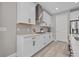 Stylish kitchen with white cabinetry, granite countertops, and a stainless steel range hood at 17676 Savory Mist Cir, Bradenton, FL 34211