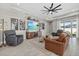 Cozy living room with wood look floors, neutral walls, ceiling fan, and comfortable seating at 17676 Savory Mist Cir, Bradenton, FL 34211