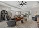 Open-concept living space with seating, a brown leather sofa, and an adjacent kitchen area with bar seating at 17676 Savory Mist Cir, Bradenton, FL 34211