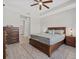 Serene main bedroom with wooden furniture, a ceiling fan, and a neutral color palette at 17676 Savory Mist Cir, Bradenton, FL 34211