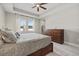 Spacious bedroom with abundant natural light, a ceiling fan, and elegant furnishings for a comfortable retreat at 17676 Savory Mist Cir, Bradenton, FL 34211