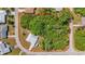Aerial view outlining the property lines of a vacant, wooded lot in a residential neighborhood at 18399 Burkholder Cir, Port Charlotte, FL 33948