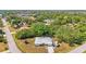 Captivating aerial view of home featuring mature landscaping and a metal roof at 18399 Burkholder Cir, Port Charlotte, FL 33948