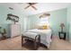Coastal-themed bedroom boasts natural light, light-colored walls, and tiled floor at 18399 Burkholder Cir, Port Charlotte, FL 33948
