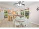 Open-concept living: breakfast nook flows into kitchen with bar seating and sunroom access at 18399 Burkholder Cir, Port Charlotte, FL 33948