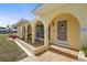 Close up of the home's inviting arched entryway and decorative front door at 18399 Burkholder Cir, Port Charlotte, FL 33948