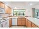 This kitchen features wood cabinets, an updated sink, and modern appliances at 18399 Burkholder Cir, Port Charlotte, FL 33948