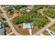 A home on an oversized lot with mature trees in a quiet residential neighborhood. Lot boundary marked in red at 18399 Burkholder Cir, Port Charlotte, FL 33948
