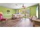 Comfortable living room features wood-look floors and refreshing green walls at 18399 Burkholder Cir, Port Charlotte, FL 33948