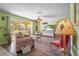 Cozy living room with large windows and light green walls at 18399 Burkholder Cir, Port Charlotte, FL 33948