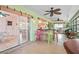 Spacious, enclosed porch with bar, seating, multiple ceiling fans, and seamless indoor/outdoor flow at 18399 Burkholder Cir, Port Charlotte, FL 33948