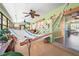 Bright porch featuring a hammock, bar area, and access to indoor living spaces through sliding glass doors at 18399 Burkholder Cir, Port Charlotte, FL 33948