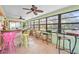 Spacious sunroom with many windows, barstool seating, and outdoor furniture offering a relaxing retreat at 18399 Burkholder Cir, Port Charlotte, FL 33948