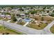 This aerial view of the property shows a well-maintained home, spacious driveway, and a neatly kept lawn at 19990 Midway Blvd, Port Charlotte, FL 33948