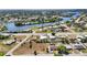 Aerial shot of a suburban neighborhood with waterfront access and lush greenery, offering a serene living environment at 19990 Midway Blvd, Port Charlotte, FL 33948