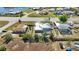 This aerial image shows a beautiful home with a screened-in pool and a fenced yard offering a blend of comfort and privacy at 19990 Midway Blvd, Port Charlotte, FL 33948