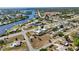 This aerial shot shows the layout of the properties in the neighborhood and showcases the river in the distance at 19990 Midway Blvd, Port Charlotte, FL 33948