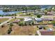 This aerial view shows a home with a screened-in pool perfect for relaxation and enjoyment in a private outdoor space at 19990 Midway Blvd, Port Charlotte, FL 33948