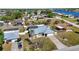 Aerial view shows the property with a screened pool, a large yard, and the proximity to a bay at 19990 Midway Blvd, Port Charlotte, FL 33948