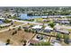 This aerial view shows a nice neighborhood along the river featuring attractive homes with pools and well-kept yards at 19990 Midway Blvd, Port Charlotte, FL 33948