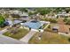 This aerial view showcases a charming home with a cozy backyard, and long driveway for multiple vehicles at 19990 Midway Blvd, Port Charlotte, FL 33948