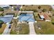 Aerial view of the home featuring a backyard with a screened-in pool and fenced yard at 19990 Midway Blvd, Port Charlotte, FL 33948