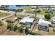 Aerial view showcasing a beautiful home with a screened-in pool, surrounded by a well-maintained fenced yard at 19990 Midway Blvd, Port Charlotte, FL 33948