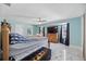 Bright primary bedroom with light blue walls, marble floors, lots of room and natural light at 19990 Midway Blvd, Port Charlotte, FL 33948