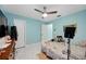 Bedroom featuring light blue walls, marble floors, a ceiling fan, and lots of room at 19990 Midway Blvd, Port Charlotte, FL 33948