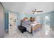 Bright bedroom features blue walls, wood furnishings, marble flooring, and natural light at 19990 Midway Blvd, Port Charlotte, FL 33948