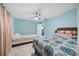 Bright bedroom with two beds, ceiling fan, and marble floors, creating a peaceful retreat at 19990 Midway Blvd, Port Charlotte, FL 33948