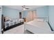 Cozy bedroom with two beds, soft blue walls and marble floors offers a comfortable space at 19990 Midway Blvd, Port Charlotte, FL 33948