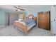 Cozy bedroom featuring marble floors, wood furnishings, bright blue walls and natural light at 19990 Midway Blvd, Port Charlotte, FL 33948