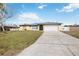 Exterior showcasing the home's curb appeal and two-car garage at 19990 Midway Blvd, Port Charlotte, FL 33948