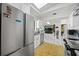 Bright kitchen featuring stainless steel appliances, white cabinets, and marble flooring at 19990 Midway Blvd, Port Charlotte, FL 33948