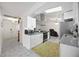 Well-lit kitchen featuring white cabinets, stainless appliances, granite counters, and modern fixtures at 19990 Midway Blvd, Port Charlotte, FL 33948