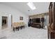Open living room with a stone accent wall, skylight, and marble floors at 19990 Midway Blvd, Port Charlotte, FL 33948