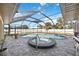 Enclosed pool and hot tub area featuring screened in enclosure and tile flooring at 19990 Midway Blvd, Port Charlotte, FL 33948