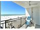 Relaxing balcony with comfortable seating offers stunning views of the beach at 20 Whispering Sands Dr # 406, Sarasota, FL 34242