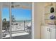 Balcony view showing seating, ocean, and beach with natural light, adjacent to the living space at 20 Whispering Sands Dr # 406, Sarasota, FL 34242